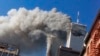 FILE - Smoke rises from the burning twin towers of the World Trade Center after hijacked planes crashed into them, in New York City, Sept. 11, 2001