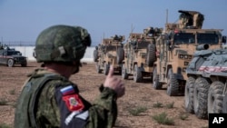 Turkish and Russian patrol is seen near the town of Darbasiyah, Syria, Nov. 1, 2019. 