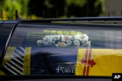 The coffin containing the body of Britain's Queen Elizabeth II leaves Balmoral Castle in Scotland, Sept. 11, 2022.