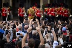 Members of the public use their phones to take photos and videos following the Accession Council ceremony at St. James's Palace, London, Sept. 10, 2022.