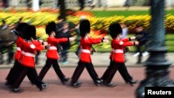 FILE - The Queen's Guard marches during the Changing of the Guard ceremony outside Buckingham Palace in London, April 21, 2016. It now will be known as the King's Guard.
