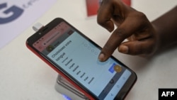 A woman chooses an African language on the 'Superphone' made by Cerco at their showroom in Abidjan on Aug. 25, 2022.