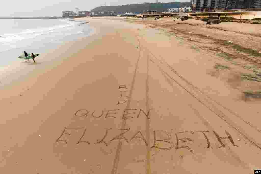 A message is written in the sand following the death of Queen Elizabeth II, on the South Beach, South Africa.