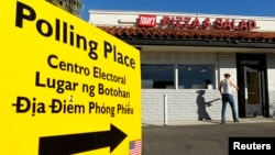 FILE - A voter arrives to cast ballots at a local restaurant being used as a polling station in California November 2, 2010. The sign has translations in Spanish, Tagalog and Vietnamese. ( REUTERS/Mike Blake /File)