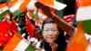 FILE- An Indian schoolgirl wears a mask of Chinese President Xi Jinping to welcome him on the eve of his visit in Chennai, India, Oct. 10, 2019. 