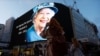 People takes photos of an image of Queen Elizabeth displayed at Piccadilly Circus n London, after she died, Sept. 8, 2022. (Reuters)