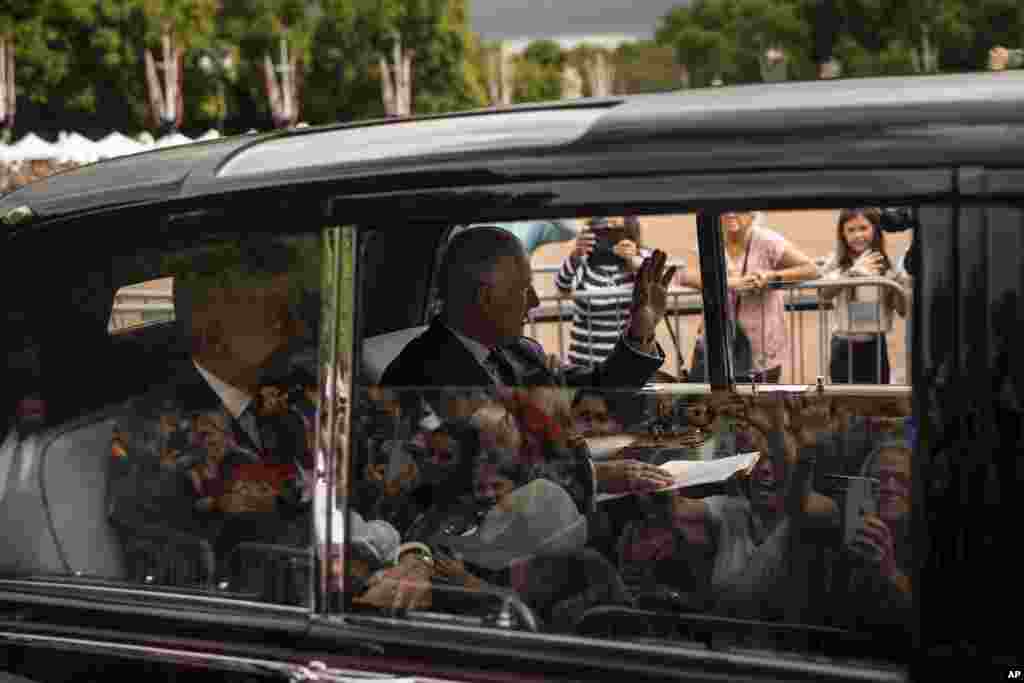 King Charles III greets supporters as he arrives at Buckingham Palace in London, Sept. 10, 2022.