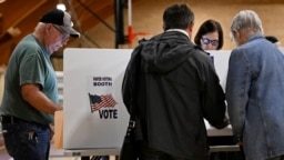 FILE - Voters cast their ballots for the midterm primary election in Grove City, Ohio, May 3, 2022.
