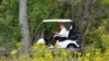 Former President Donald Trump rides around his golf course at Trump National Golf Club in Sterling, Va., Sept. 12, 2022.