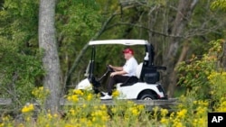 Former President Donald Trump rides around his golf course at Trump National Golf Club in Sterling, Va., Sept. 12, 2022.