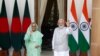 Indian Prime Minister Narendra Modi, right, and his Bangladeshi counterpart Sheikh Hasina wave to the waiting media before their delegation level talks in New Delhi, India, Sept. 6, 2022.