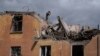 A firefighter works to extinguish a fire as he looks for potential victims after a Russian attack that damaged a residential building in Sloviansk, Ukraine, Sept. 7, 2022.