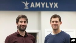 FILE - This 2018 photo provided by Amylyx shows company co-founders Joshua Cohen, left, and Justin Klee in Cambridge, Mass. A closely watched experimental drug for Lou Gehrig’s disease is getting an unusual second look from U.S. regulators.