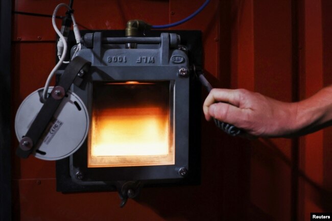 The furnace of a biomass generator is seen through a window at a greenhouse in Grubbenvorst, Netherlands September 5, 2022. REUTERS/Piroschka van de Wouw