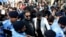 Former Pakistani Prime Minister Imran Khan, center, arrives to the Islamabad High Court surrounded by journalists and security in Islamabad, Pakistan, Sept. 8, 2022.
