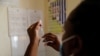 FILE - A nurse fills a syringe with malaria vaccine before administering it to an infant at the Lumumba Sub-County hospital in Kisumu, Kenya, July 1, 2022. 