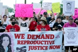 Protesters march around the Arizona Capitol after the Supreme Court decision to overturn the landmark Roe v. Wade abortion decision on June 24, 2022, in Phoenix.