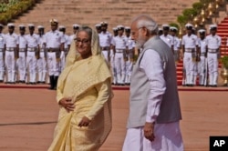 Indian Prime Minister Narendra Modi, right, with his Bangladeshi counterpart Sheikh Hasina pose for the photograph during her ceremonial reception at the Indian presidential palace in New Delhi, India , Tuesday, Sept. 6, 2022. (AP Photo/Manish Swarup)