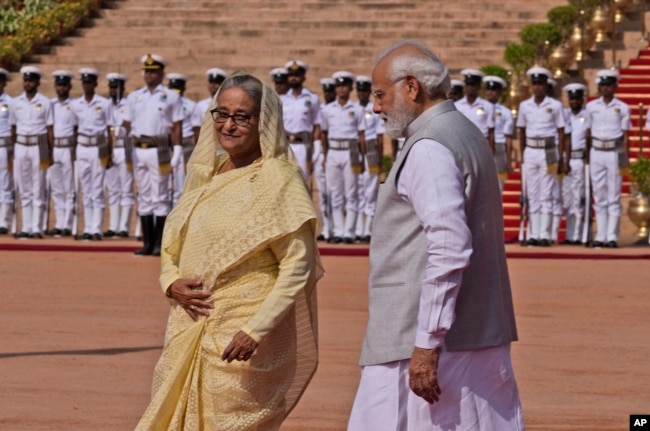 Indian Prime Minister Narendra Modi, right, with his Bangladeshi counterpart Sheikh Hasina pose for the photograph during her ceremonial reception at the Indian presidential palace in New Delhi, India , Tuesday, Sept. 6, 2022. (AP Photo/Manish Swarup)