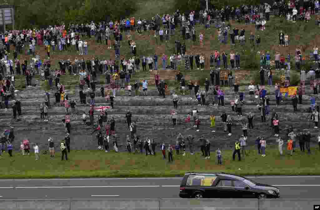 The cortege with the hearse carrying the coffin of Queen Elizabeth II drives on the M90 motorway as it makes its journey to Edinburgh from Balmoral in Scotland, Sept. 11, 2022.