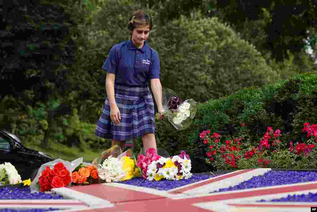 A mourner leaves flowers outside the British Embassy following the death of Queen Elizabeth II, in Washington, Sept. 8, 2022.