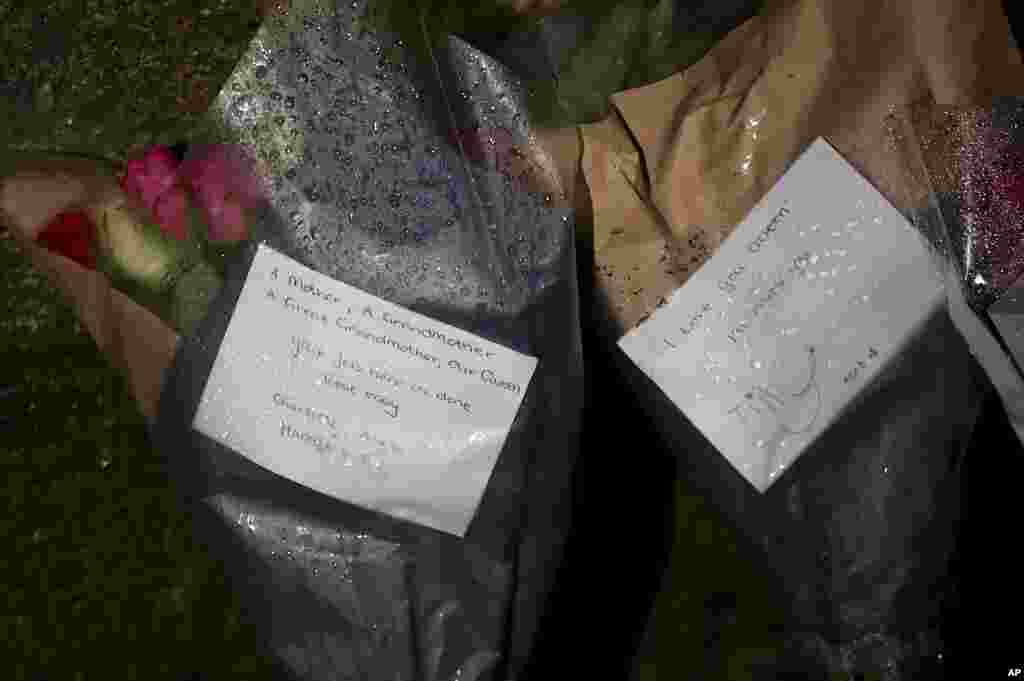 Notes accompany floral arrangements placed in front of the gates of Balmoral Castle, after the announcement of the death of Queen Elizabeth II, in Aberdeenshire, Scotland, Sept. 8, 2022.