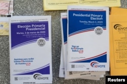 English and Spanish-language sample ballots and voter information pamphlets for the California Democratic presidential primary are seen at a polling place in Del Mar, California, on March 3, 2020. (REUTERS/Bing Guan)