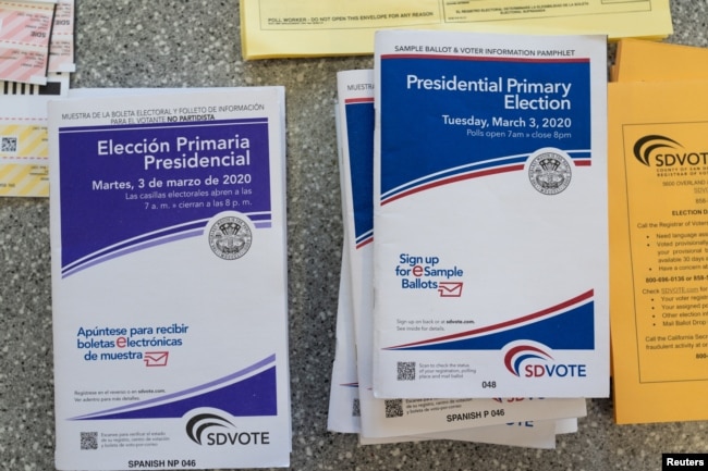 English and Spanish-language sample ballots and voter information pamphlets for the California Democratic presidential primary are seen at a polling place in Del Mar, California, on March 3, 2020. (REUTERS/Bing Guan)