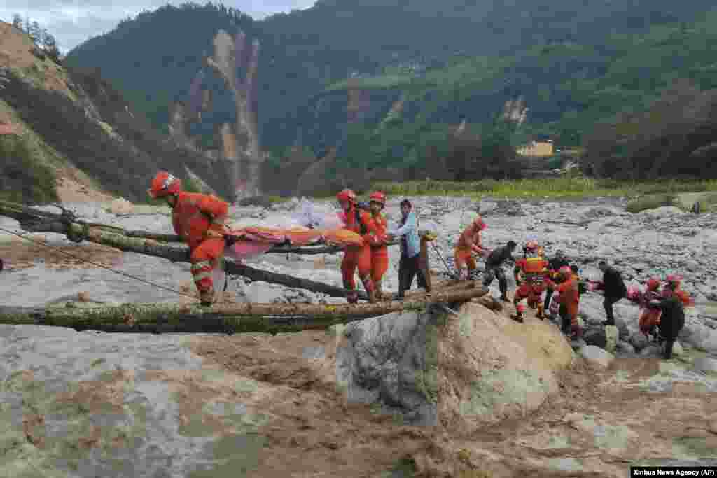 Rescuers transfer survivors across a river following an earthquake in Moxi Town of Luding County, southwest China's Sichuan Province, Sept. 5, 2022.