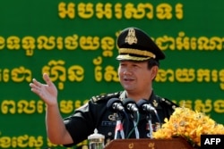 FILE - Cambodian Armed Forces deputy commander-in-chief Lt Gen Hun Manet speaks during a ceremony to deploy 290 recently purchased Chinese military trucks to its security forces at the National Olympic stadium in Phnom Penh on June 18, 2020.