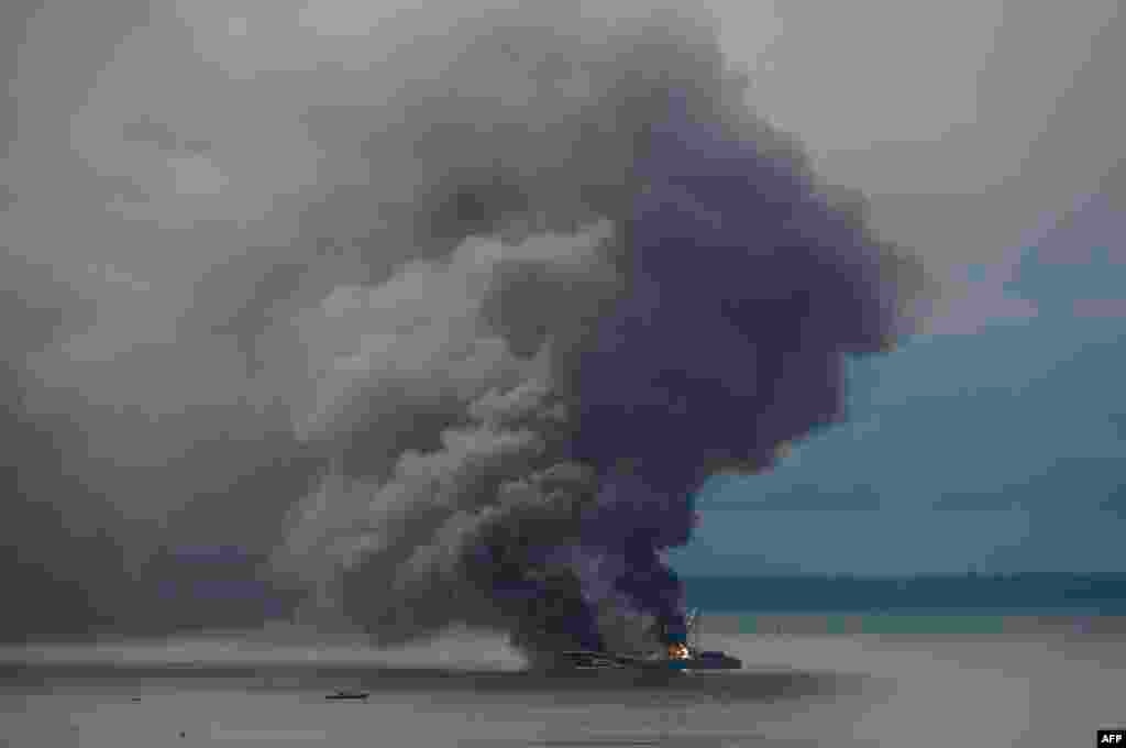 Smoke rises from Venezuelan ship Taurus 1 burning in the Buenaventura Bay, Valle del Cauca department, Colombia.