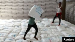  Laborers offload bags of grains as part of relief food that was sent from Ukraine at the World Food Program (WFP) warehouse in Adama town, Ethiopia, September 8, 2022. 