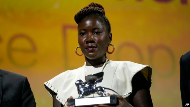 Director Alice Diop holds the Silver Lion Grand Jury Prize for