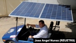 Jose Cintron sits in a solar-powered car he developed, in Maracaibo, Venezuela August 30, 2022. REUTERS/Jose Angel Nunez

