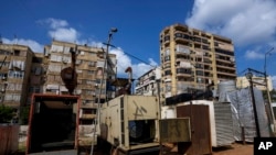 FILE - A row of privately-owned diesel generators provide power to homes and businesses in Beirut, Lebanon, March 4, 2022.