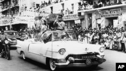 FILE - Britain's Queen Elizabeth II and Pakistan's President Ayub Khan acknowledge cheers as they ride in a motorcade through Karachi, Pakistan, Feb. 1, 1961. 