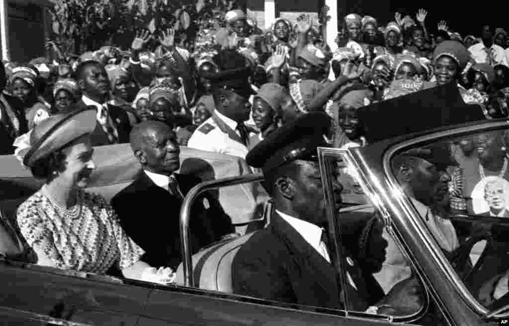 Thousands of Malawian women cheer and wave their hands at Britain&#39;s Queen Elizabeth II and Malawi&#39;s President Hastings Banda as they drive from the airport in Blantyre, Malawi on July 22, 1979.the Queen is on the second leg of her four-nation African tour. (AP Photo)