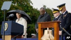 President Joe Biden stands with Defense Secretary Lloyd Austin and Chairman of the Joint Chiefs, Gen. Mark Milley, during a moment of silence during a ceremony at the Pentagon, Sept. 11, 2022.