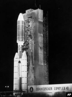 In this Aug. 20, 1977 file photo, a Titan/Centaur 7 rocket stands ready at the launch pad with the 1,800-pound Voyager spacecraft at the Kennedy Space Center in Florida. The spacecraft departed from Cape Canaveral to explore Jupiter and Saturn. (AP Photo/