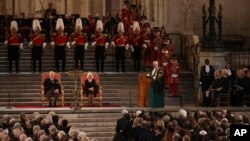 King Charles III and Camilla, the Queen Consort listen to Speaker of the House of Commons Sir Lindsay Hoyle, in Westminster Hall, where both Houses of Parliament met to express their condolences, following the death of Queen Elizabeth II, in London, Sept.
