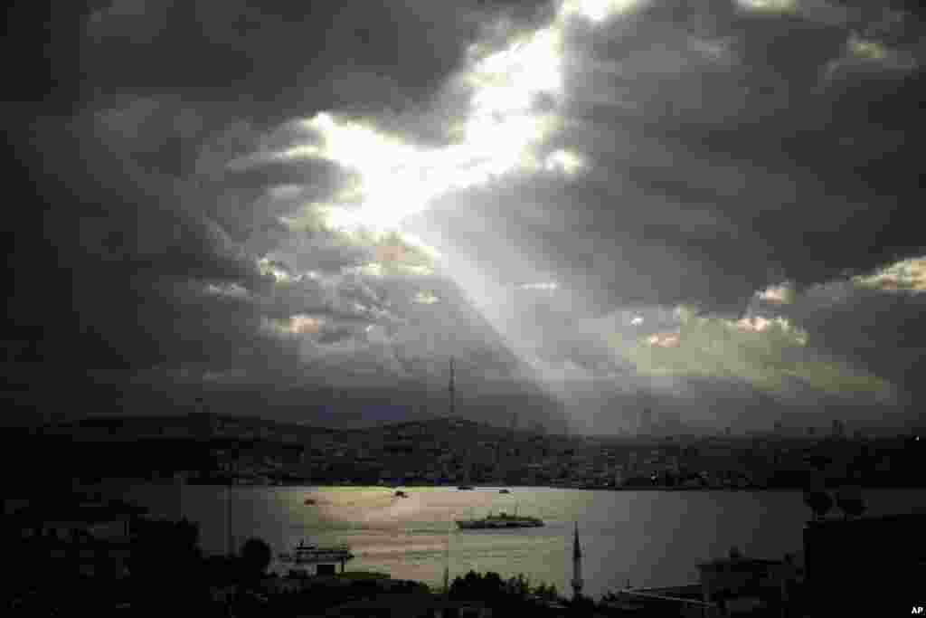 Ferries sail along the Bosphorus as the sun rises in Istanbul, Turkey.