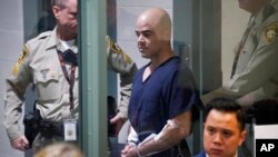 FILE - Then-Clark County Public Administrator Robert Telles is escorted into court on Sept. 8, 2022, in Las Vegas, Nevada. Telles was arrested in the fatal stabbing of Las Vegas Review-Journal reporter Jeff German. His trial is set to begin on Aug. 12, 2024.