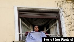 Sandra Delgadillo, trabajadora del hogar de origen boliviano, cuelga su uniforme durante la huelga del Día Internacional de la Mujer.