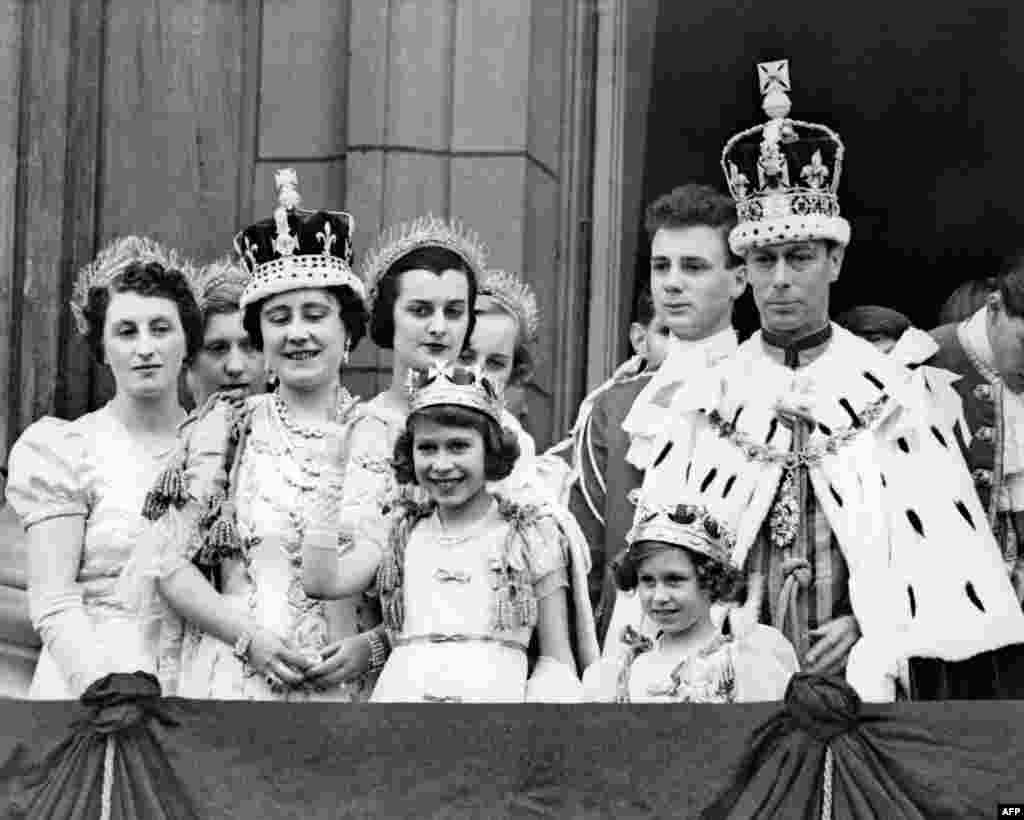 Queen Elizabeth, second from left, future Queen Mother; her daughter Princess Elizabeth, front center, future Queen Elizabeth II; Princess Margaret, front right; and King George VI, right, pose on the Buckingham Palace balcony, May 12, 1937, following his coronation.