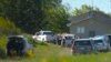 In this image taken from video, Canadian law enforcement personnel surround a residence on the James Smith Cree First Nation reserve in Saskatchewan, Canada, Sept. 6, 2022, as they search for a suspect in a series of stabbings. 