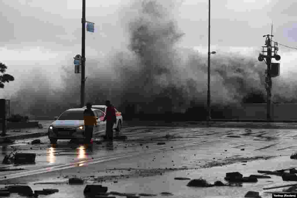 A wave caused by Typhoon Hinnamnor hits the waterfront in Busan, South Korea.