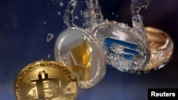FILE - Representations of cryptocurrency Bitcoin, Ethereum and Dash plunge into water in this illustration taken, May 23, 2022.