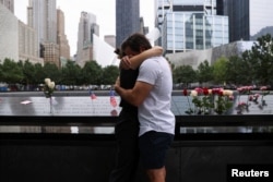 FILE - People react during a ceremony marking the 21st anniversary of the September 11, 2001 attacks on the World Trade Center at the 9/11 Memorial and Museum in the Manhattan borough of New York City, U.S., September 11, 2022. (REUTERS/Amr Alfiky)