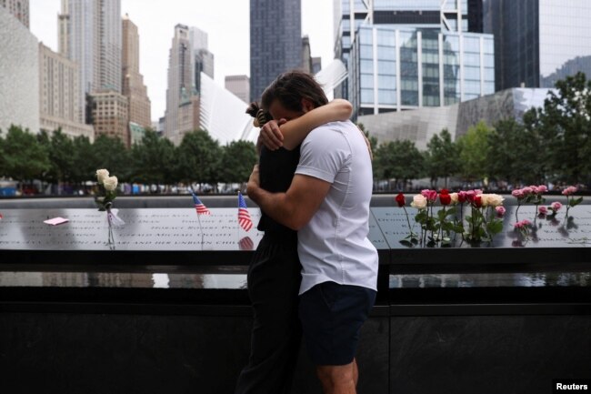 FILE - People react during a ceremony marking the 21st anniversary of the September 11, 2001 attacks on the World Trade Center at the 9/11 Memorial and Museum in the Manhattan borough of New York City, U.S., September 11, 2022. (REUTERS/Amr Alfiky)