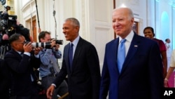 President Joe Biden and former President Barack Obama arrive in the East Room of the White House in Washington, Sept. 7, 2022, for the unveiling of the official White House portraits of the former president and his wife.